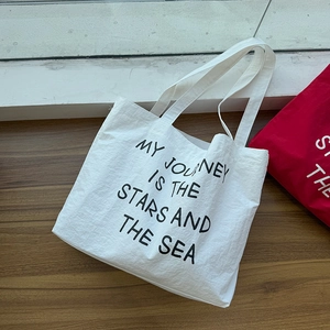 Close-up of lightweight nylon tote bag with My Journey Is The Stars And The Sea print