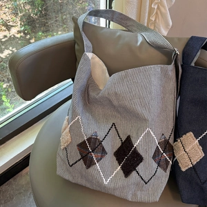 Close-up of canvas tote bag with striped pattern and textured diamond stitching detail