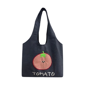 Dark blue denim tote bag featuring a cute red tomato embroidery and white Tomato text