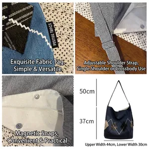 Denim tote bag with plaid embroidery, adjustable strap, and magnetic buckle details