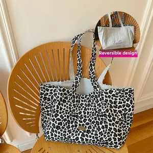 Detail showing the reversible design of the leopard print canvas tote bag with text
