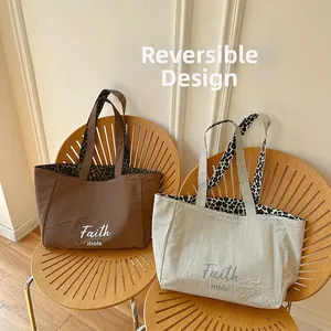 Reversible canvas tote bag showing solid color exterior and leopard print interior