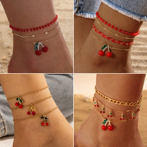 Three-piece red beaded cherry anklet set with gold chains and rhinestone charms