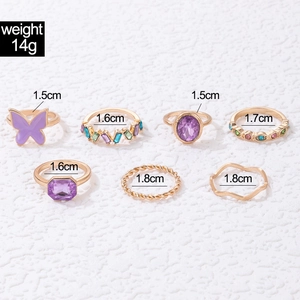 Seven-piece gold alloy ring set with butterfly, colorful gems, and twisted textures
