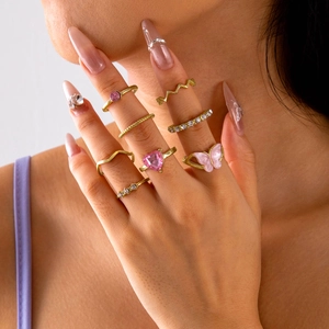 Fashionable gold ring set featuring pink heart zircon and butterfly motifs on fingers