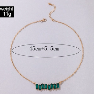 Detail of gold chain necklace with nine rectangular emerald green stones and dimensions
