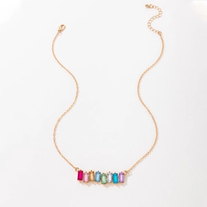 Detailed close-up of a gold chain necklace with eight vibrant multi-color rectangular gems