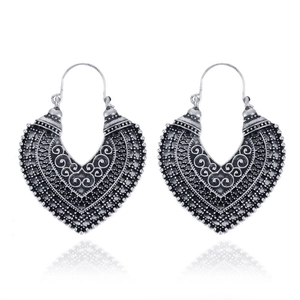 Detailed view of silver ethnic earrings featuring hollow floral patterns and v-shape design