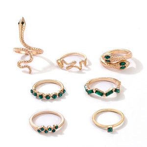 7-piece gold-toned bohemian snake and geometric ring set with green rhinestones