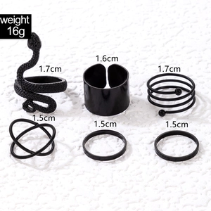 Detailed view of 6-piece black punk rings set featuring carved snake and spiral designs
