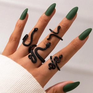 Punk style black snake ring set for women featuring matte and textured serpent designs