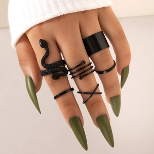 Close-up of a 6-piece matte black snake ring set with punk aesthetic on model fingers