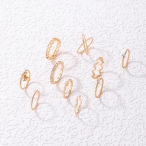 Close-up of a 10-piece gold ring set featuring heart, star, and rhinestone details