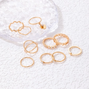 9-piece gold ring set with heart charms, crystal bands, and hollow-out designs