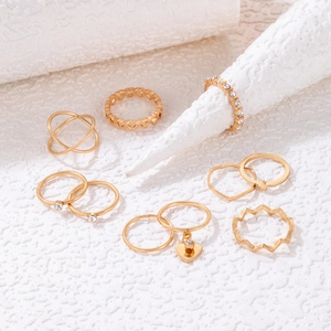 9-piece gold-plated heart ring set with pearl and rhinestone accents on white backdrop