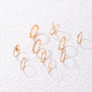 Detailed flat lay of a 10-piece gold ring set featuring heart and star designs