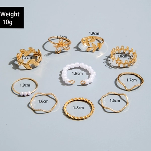 Set of 10 gold-finish rings with pearl accents and leaf designs including size details
