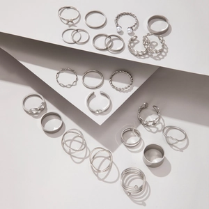 Detailed view of a silver minimalist ring set featuring butterfly and heart designs