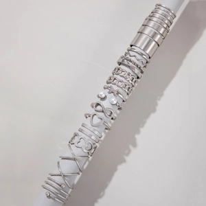 Detailed set of silver-tone rings with butterfly and heart charms on a display rod