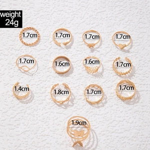 Flat lay of 13 gold alloy butterfly and heart rings with diameter measurements