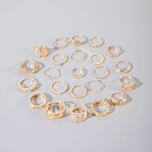 Detailed flat lay of a 21-piece gold ring set featuring rhinestones and geometric patterns