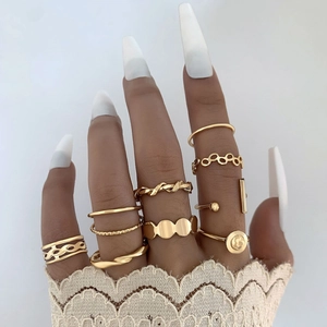 Detail of 10pcs bohemian gold ring set featuring twist and geometric designs on hand