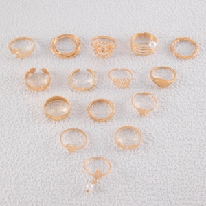 Flat lay macro of 15 pieces gold butterfly heart ring set for women on white background