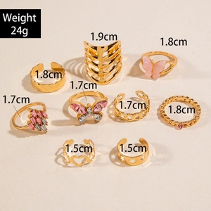 9-piece gold ring set featuring pink butterfly designs and rhinestone heart accents