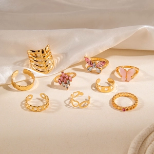 Set of 9 gold-tone rings featuring pink crystal butterflies and镂空 heart patterns