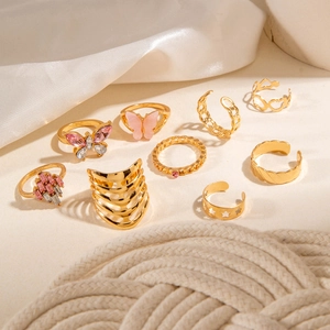 Detail shot of a 9-piece gold ring set featuring pink butterfly and hollow heart designs