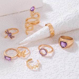 8-piece gold bohemian ring set featuring purple gems, butterfly, and snake motifs