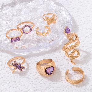 8-piece gold bohemian ring set featuring purple gemstones and diverse animal shapes