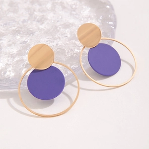 Detalle de pendientes geométricos minimalistas con discos dorados y acentos morados mate