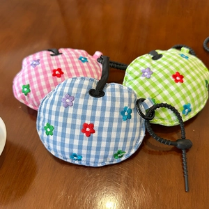 Three plaid apple-shaped earphone case charms with flower embroidery in pink, blue, and green