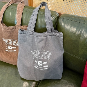 Retro washed canvas tote bag in brown and blue with paisley prints and WEST graphics