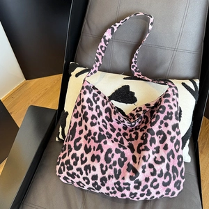 Detail of pink leopard print canvas tote bag with soft texture and wide strap