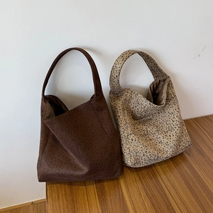 Detailed view of leopard print hobo bags in dark and light khaki woolen fabric