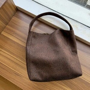 Detailed view of dark brown leopard print tote bag with minimalist wide shoulder strap