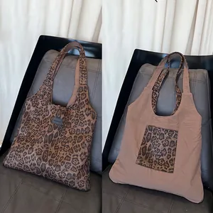 Detail view of the reversible leopard print tote bag showing both stylish suede sides