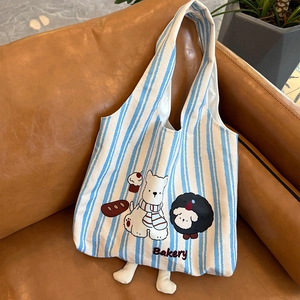 Blue and white striped canvas tote bag with cartoon bakery dog print and soft 3D leg charms
