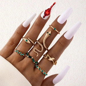 Set de 7 bagues serpent dorées avec strass verts dans un style bohème à empiler