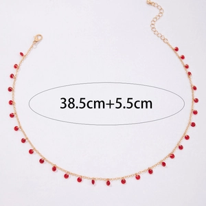 Detail view of gold clavicle necklace with red stone pendants and size 38.5cm+5.5cm