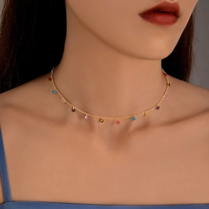 Close-up of a necklace with colorful translucent beads on a delicate gold chain