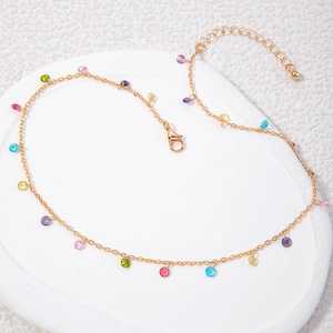 Detailed view of the gold necklace featuring vibrant colorful round gemstone pendants