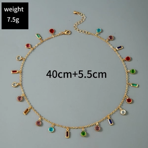 Detailed shot of gold clavicle necklace with multi-colored stones and 5.5cm extender chain