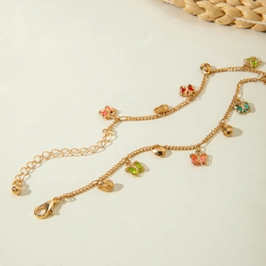 Detail of gold butterfly anklet with multi-colored charms and adjustable lobster clasp