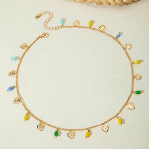 Detail view of gold necklace with colorful teardrop beads and hollow heart pendants