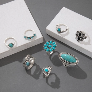 Detailed view of 8-piece vintage silver rings with turquoise stones and eagle feather motifs