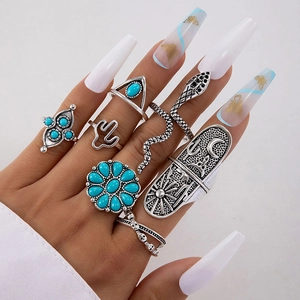 Bohemian vintage silver ring set with turquoise stones featuring snake and floral motifs