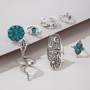 Close-up of Bohemian retro rings set with turquoise, flower and cactus motifs